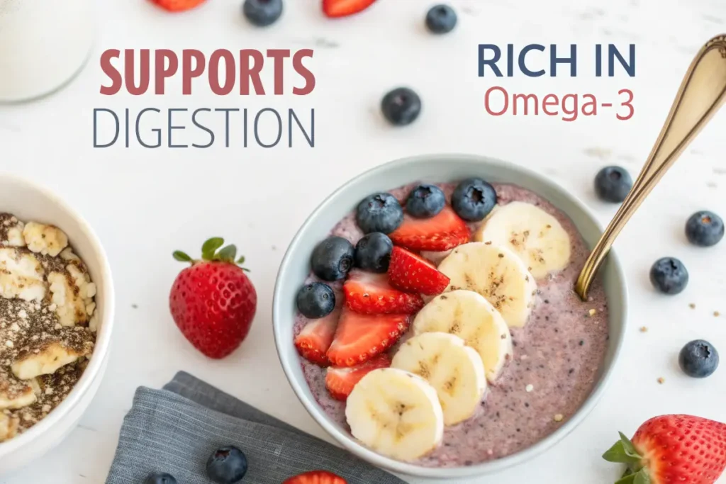 A bowl of smoothie topped with sliced bananas, strawberries, and blueberries sits on a table next to a bowl of cereal, milk, and scattered berries.